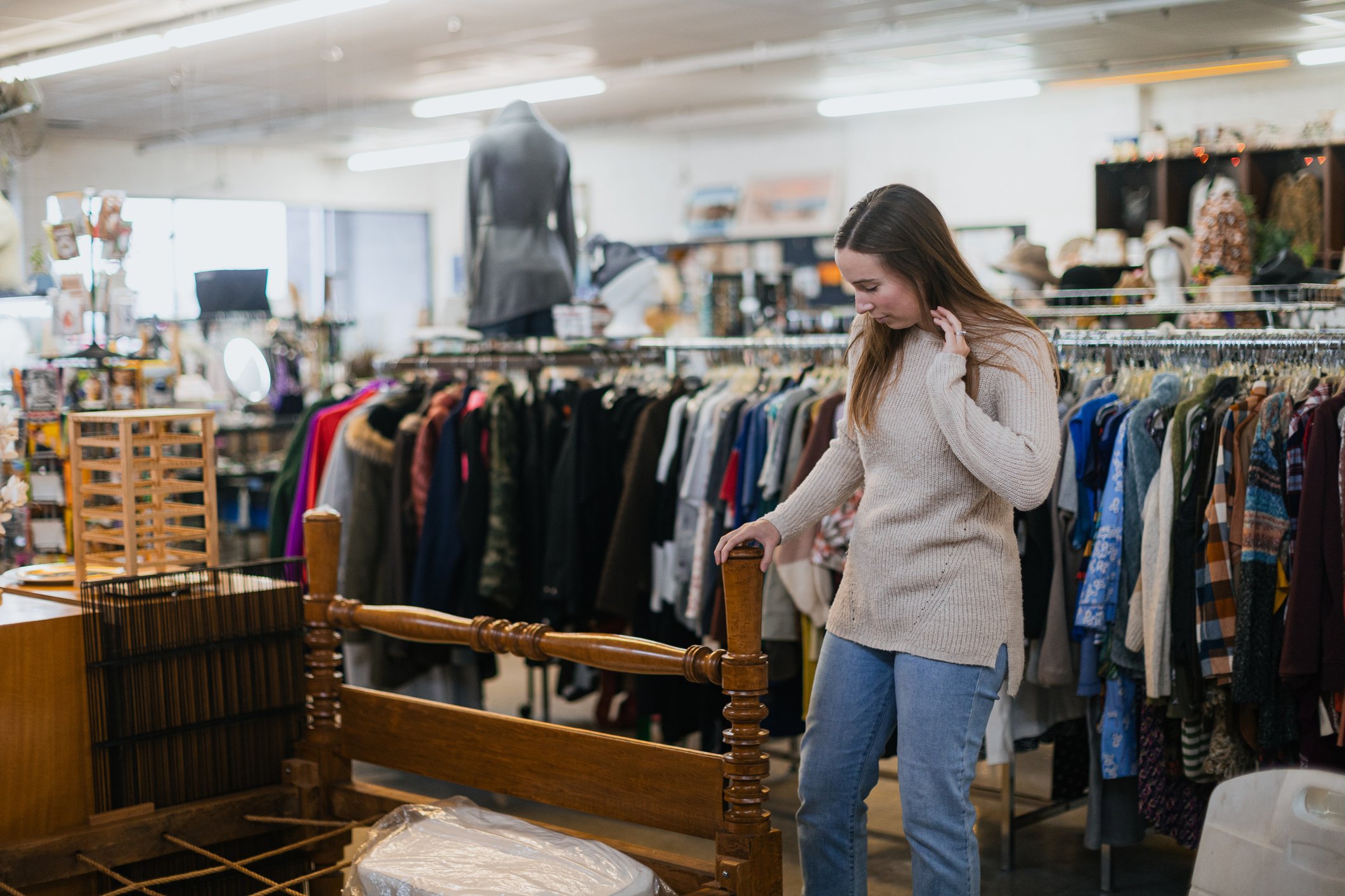 Young Woman Shopping At Second Hand Thrift Store in City financial tips