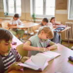 school girl and boy pupils attend class in the classroom