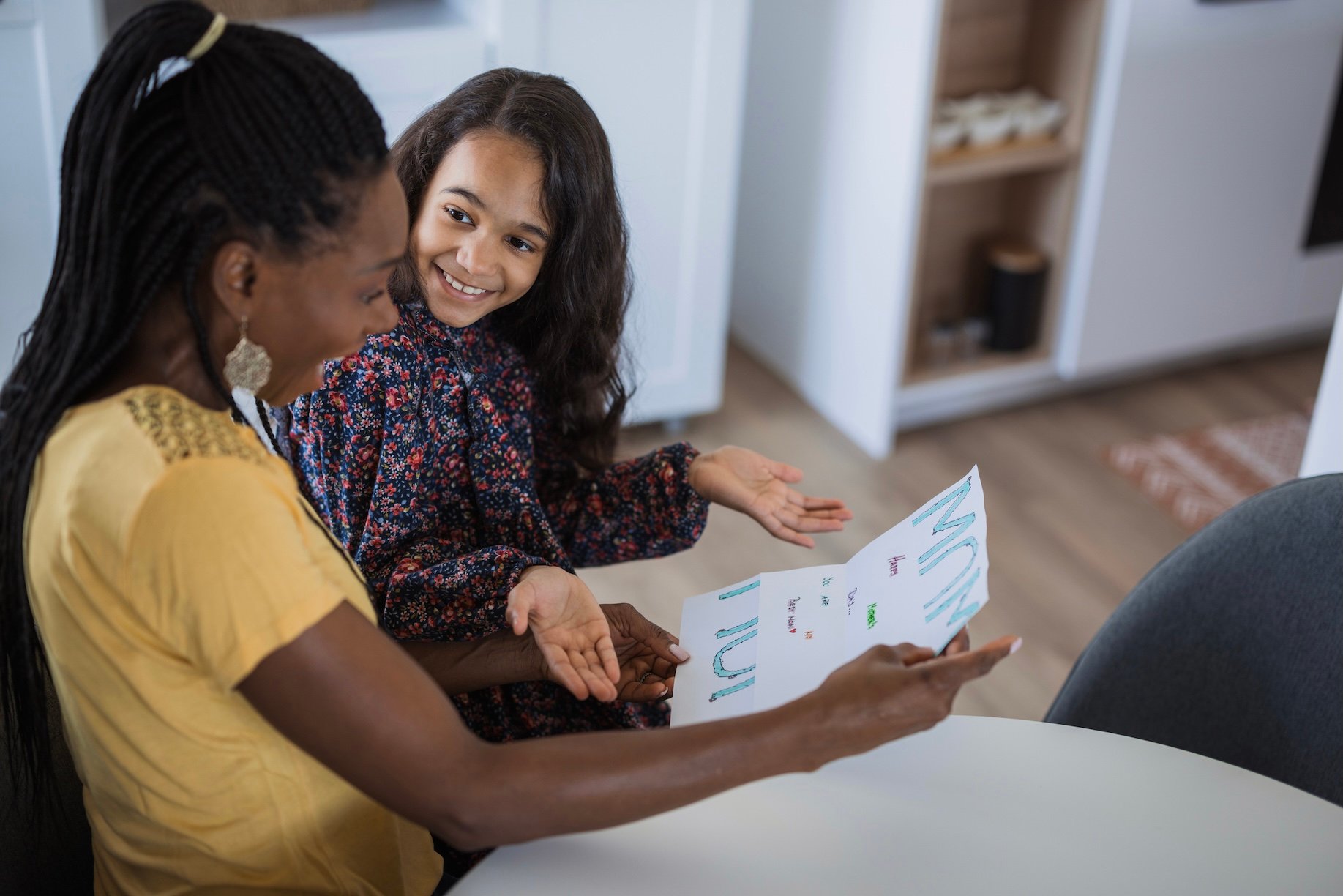 Daughter and mom looking over a chore chart
