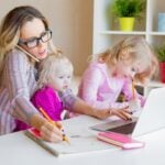 Busy woman trying to work while babysitting two kids