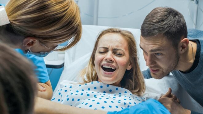 Woman in active labor with her partner by her side