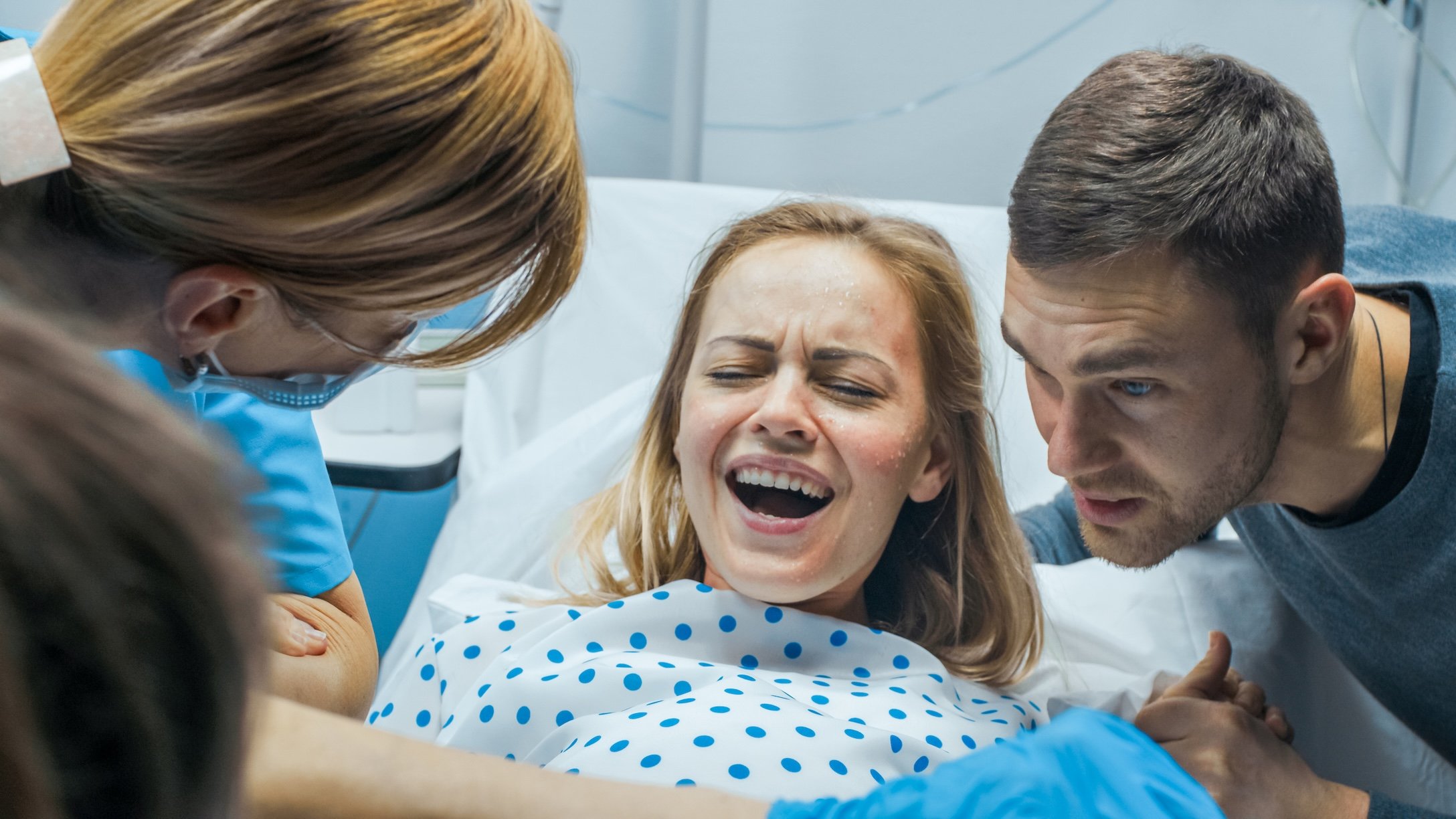 Woman in active labor with her partner by her side