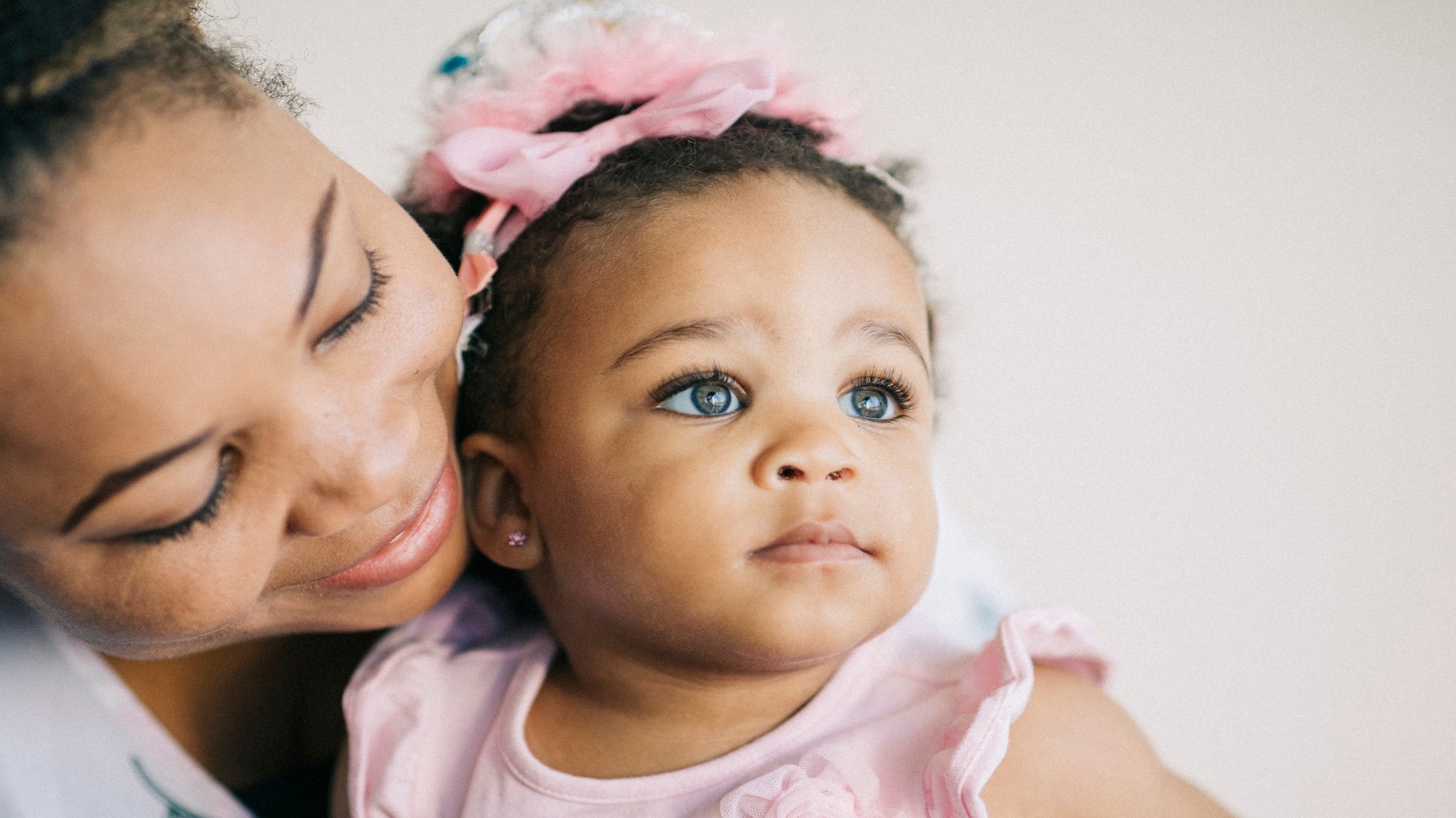 mom holding baby who has her ears pierced