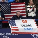man-holding-sign-usa-olympics