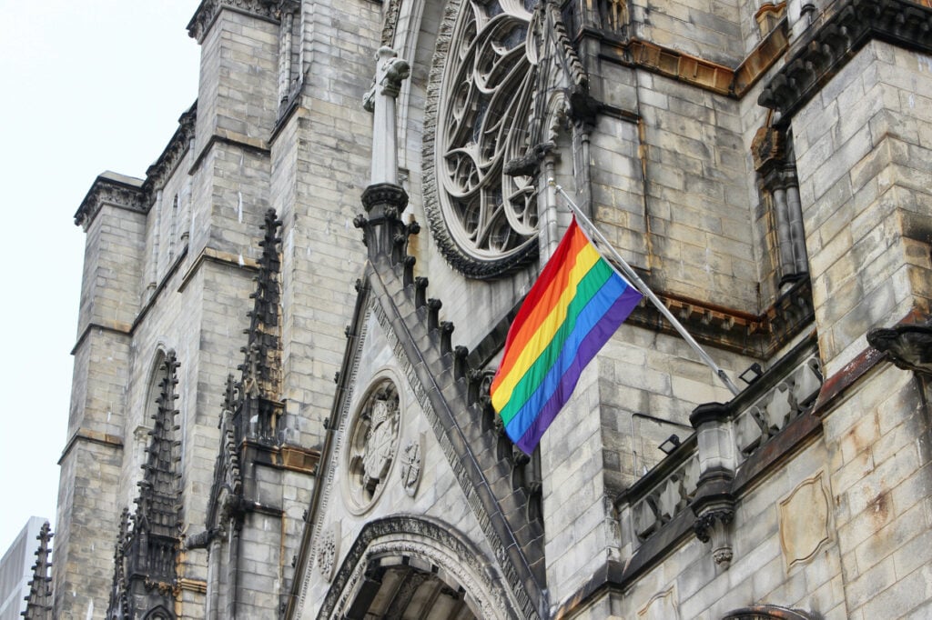 Pride flag flying on the facade of Cathedral Church of St. John the Divine in Morningside Heights, Manhattan, New York City in May 2025