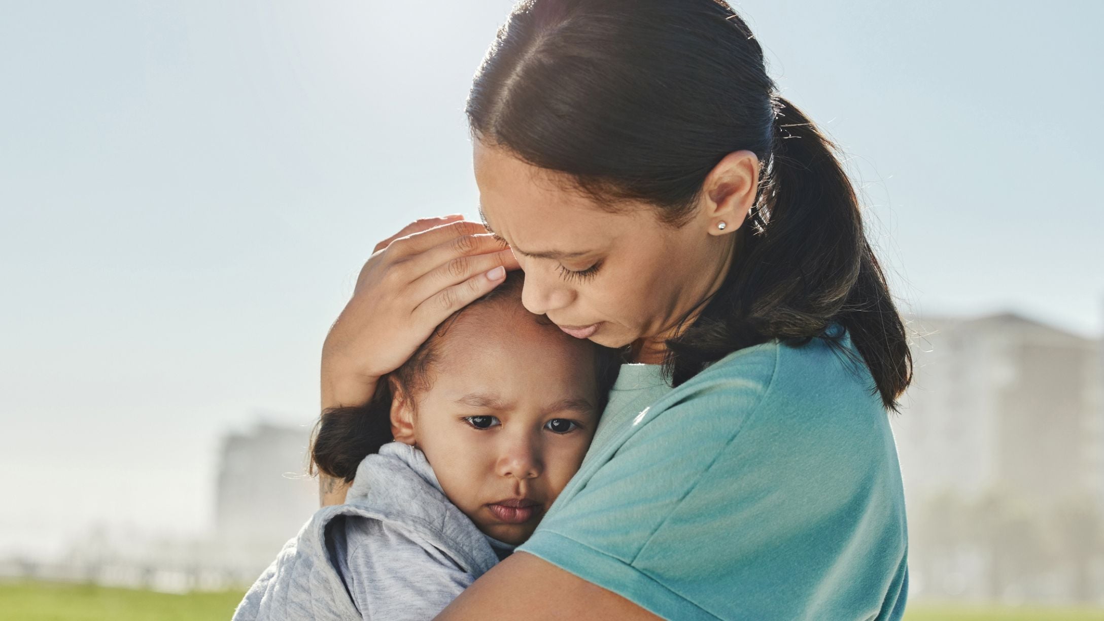 A mom embraces her sad child who needs comforting