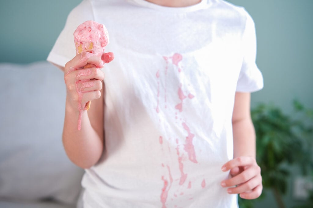 The child stained his clothes with ice cream.