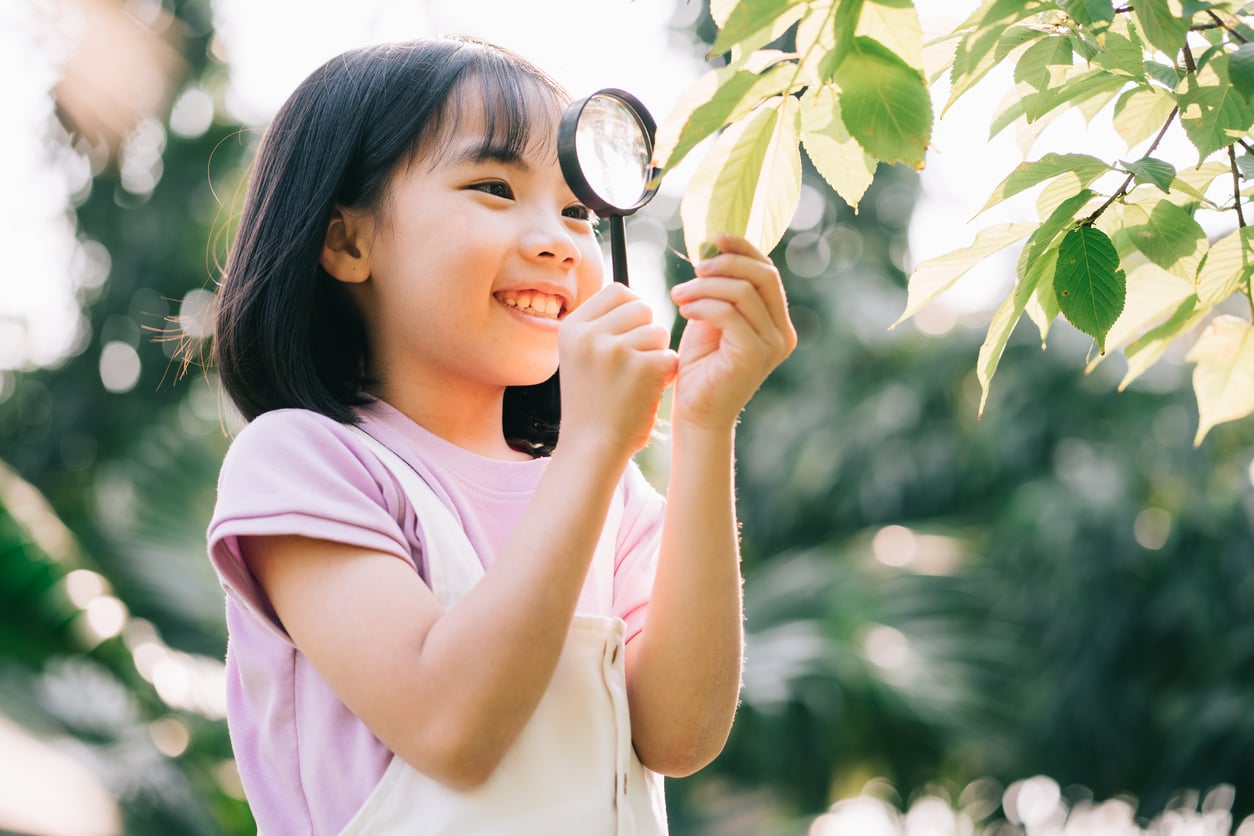 girl observing leaf