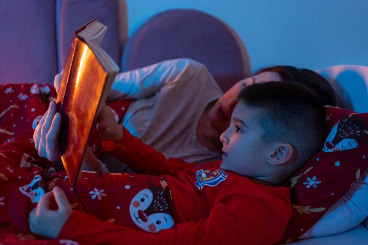 Mother and son reading book at bedtime